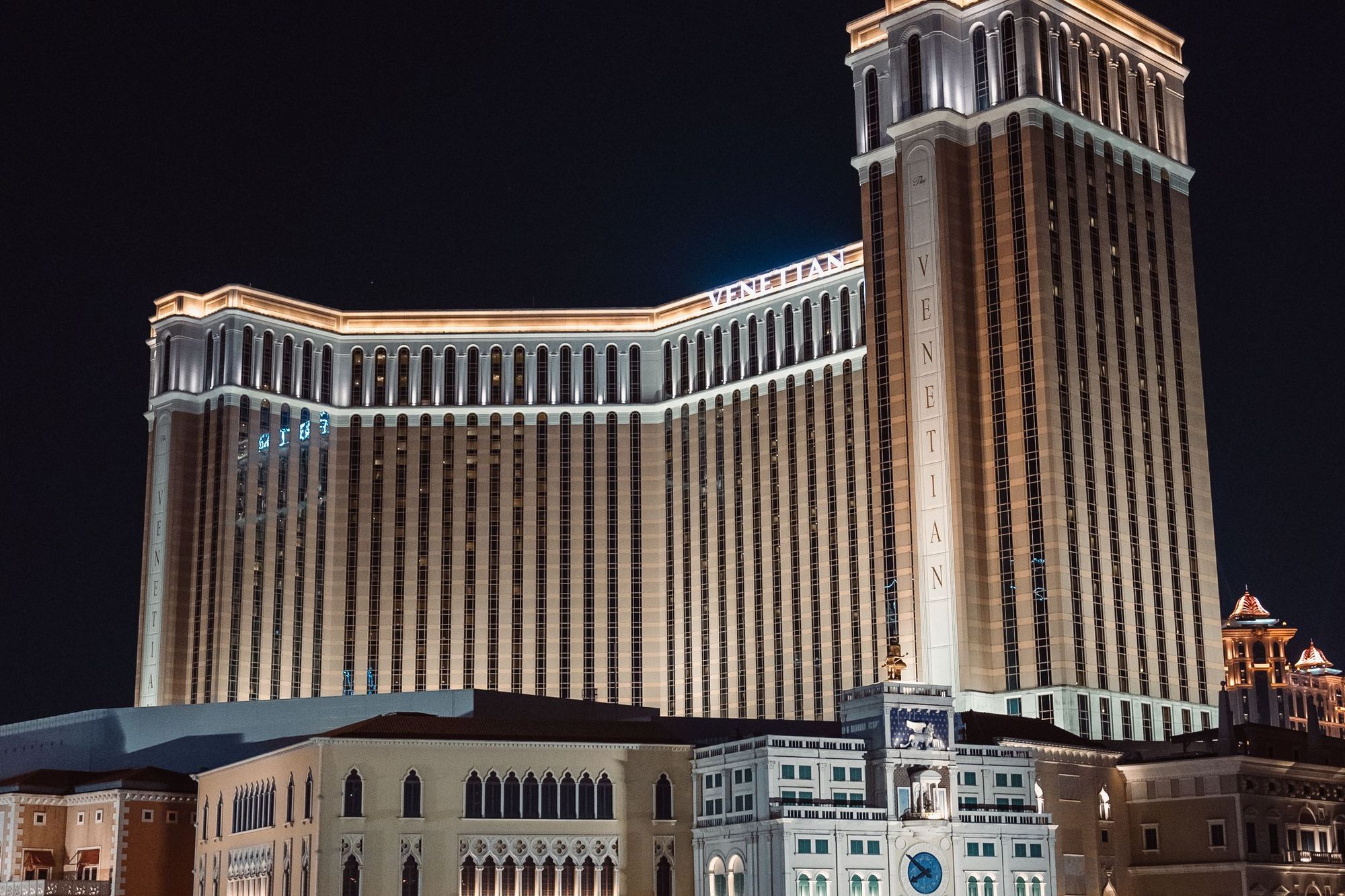 The Venetian Macao resort lit up at night with reflections on the water